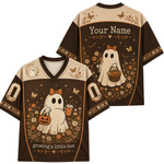 A custom football-style jersey shown from the front and back, featuring a brown and beige color scheme with a cartoon ghost holding a pumpkin and cup, surrounded by flowers and butterflies. The back has a placeholder text 'Your Name' and the front has 'Growing a little boo'.