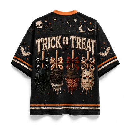 A black short-sleeve t-shirt with a distressed Halloween graphic print featuring the words 'TRICK OR TREAT' and horror-themed motifs like skulls, bats, a hockey mask, and a pumpkin on sticks, shown against a plain white background.