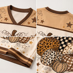 A four-panel close-up collage of a short-sleeve athletic jersey top, showing the V-neck collar, shoulder panels with brown stars, and a front print featuring patterned pumpkins, stars, and swirls in tan, brown, cream, and black.
