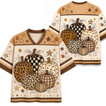 A V-neck short-sleeve shirt shown from both front and back, featuring a fall harvest pumpkin print in beige, brown, black, and white tones with stars and swirl details.