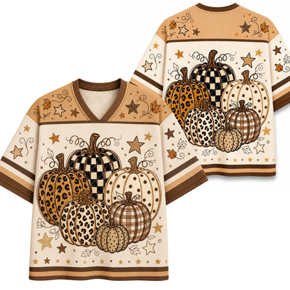 A V-neck short-sleeve shirt shown from both front and back, featuring a fall harvest pumpkin print in beige, brown, black, and white tones with stars and swirl details.