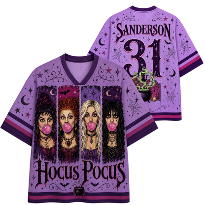A purple short-sleeve V-neck jersey-style shirt shown from both front and back on a white background. The front features four witch portraits blowing pink bubblegum, the words 'Hocus Pocus,' stars, moons, and spiderweb graphics.