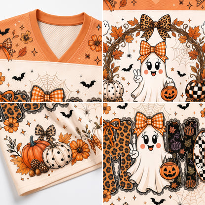 A four-panel close-up collage showing a Halloween-themed V-neck top with orange collar and a cream body printed with autumn leaves, pumpkins, ghosts, bats, spiderwebs, leopard-print bows, and checkered motifs.