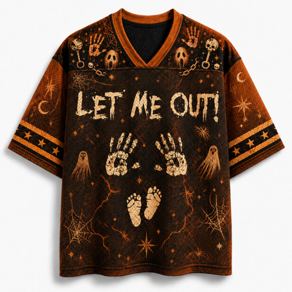 A short-sleeve V-neck t-shirt with a Halloween theme, featuring the text 'LET ME OUT!' in distressed white letters over a dark brown and black background with handprints, skulls, ghosts, and stars.