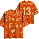 An orange short-sleeve V-neck t-shirt with a distressed white Halloween graphic print featuring ghosts, footprints, handprints, skulls, and the text 'LET ME OUT!' on the front, with 'TRAPPED SPIRIT' and the number '13' on the back.